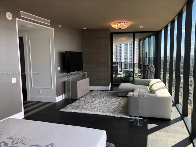 a bedroom with a bed and a night stand