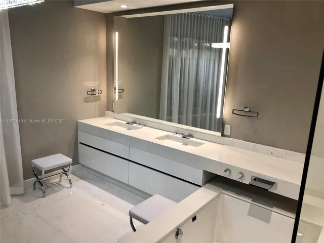a bathroom with a shower and a sink