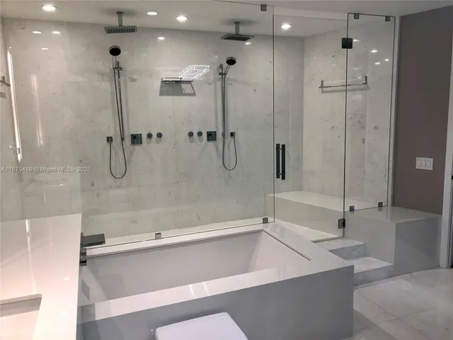 a view of a hallway with wooden floor and windows