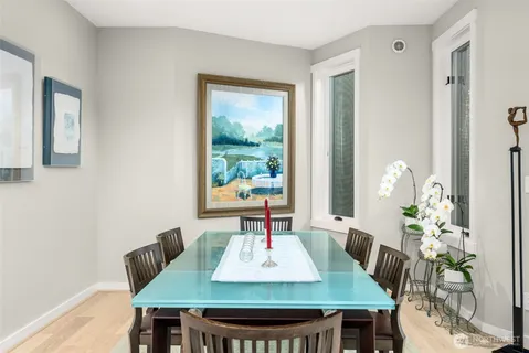 a view of a dining room with furniture and wooden floor