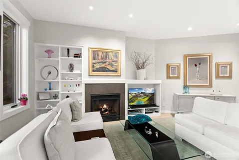 a living room with furniture fireplace and window