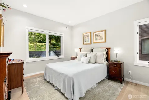 a bedroom with a bed and a large window