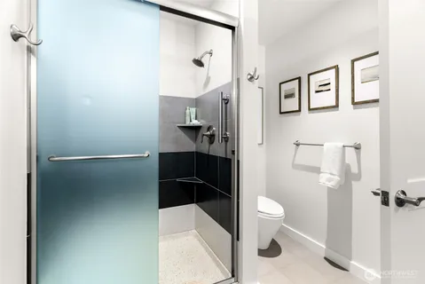 a bathroom with a granite countertop toilet sink and shower