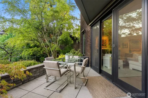 a view of a patio with table and chairs and potted plants