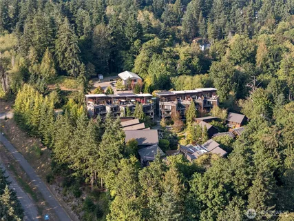 an aerial view of a house with a yard fountain and outdoor seating