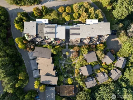 an aerial view of a house with a yard and sitting area