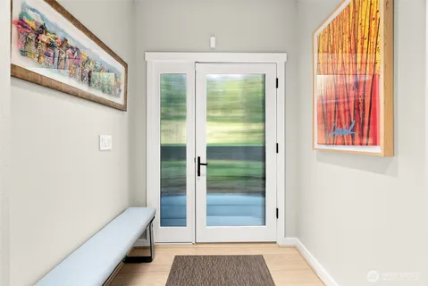 a view of an entryway with wooden floor