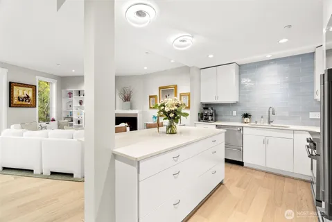 a large white kitchen with cabinets
