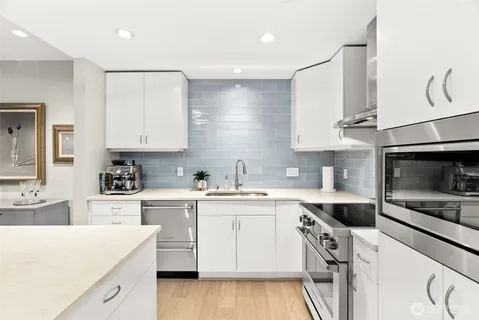a kitchen with a sink a stove and cabinets