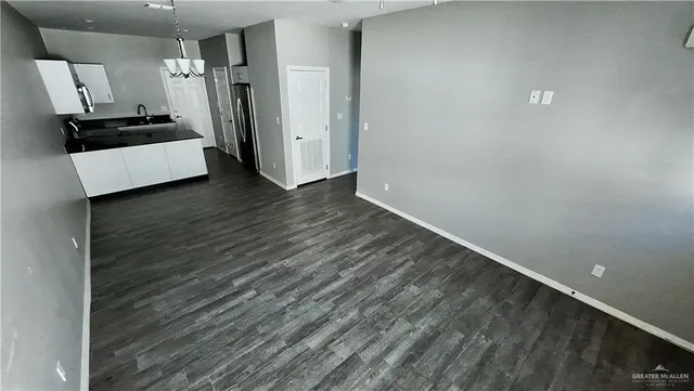a view of a refrigerator in kitchen and wooden floor