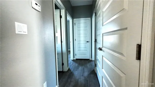 a view of a hallway with wooden floor