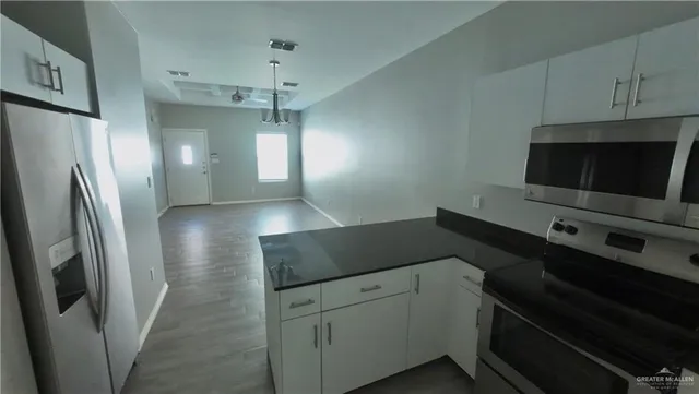 a kitchen with a refrigerator and a sink