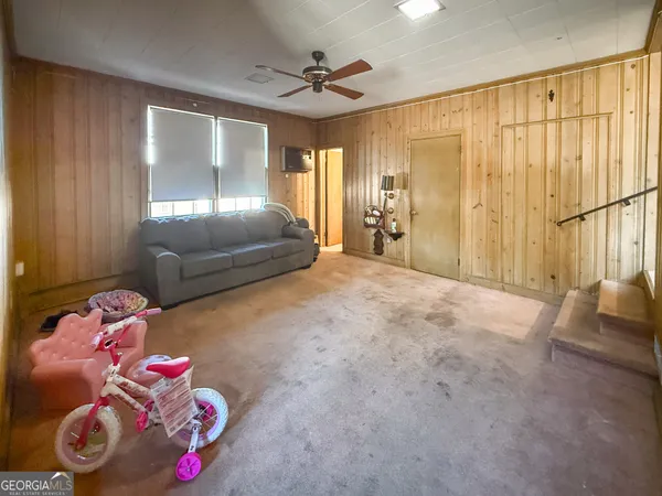 a bedroom with furniture and a chandelier fan