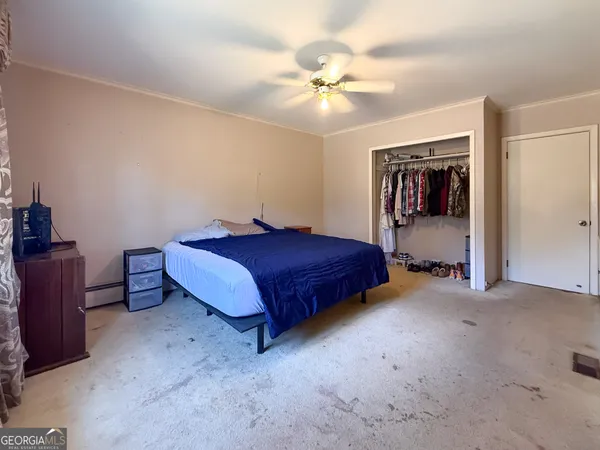 a spacious bedroom with a bed and a chandelier