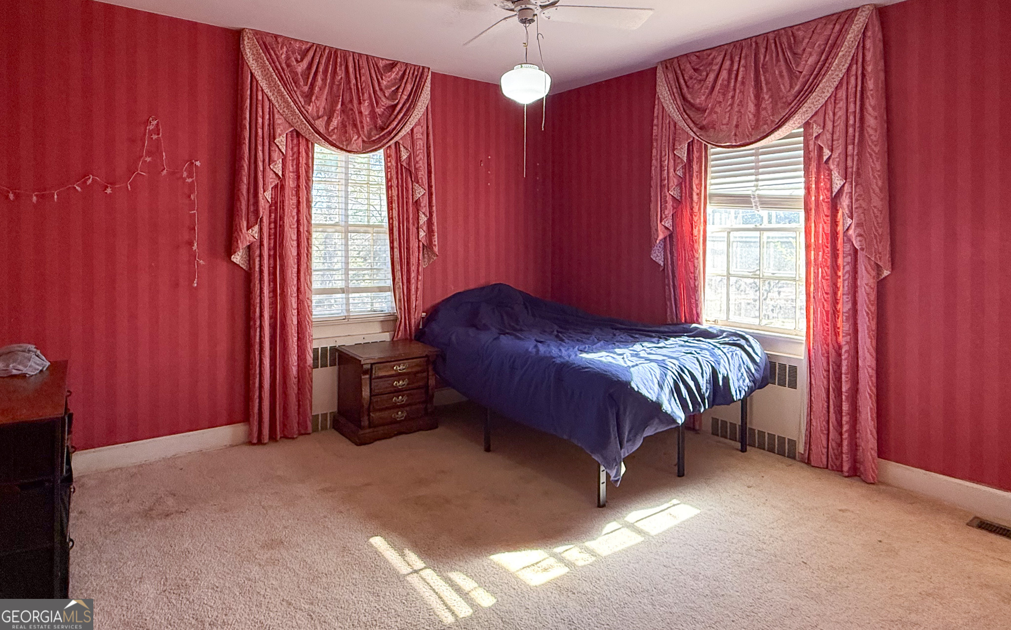 509 Youngs Mill Road LaGrange, GA 30241 - Photo 22 of 28 a bed sitting in a bedroom next to a window and a chandelier