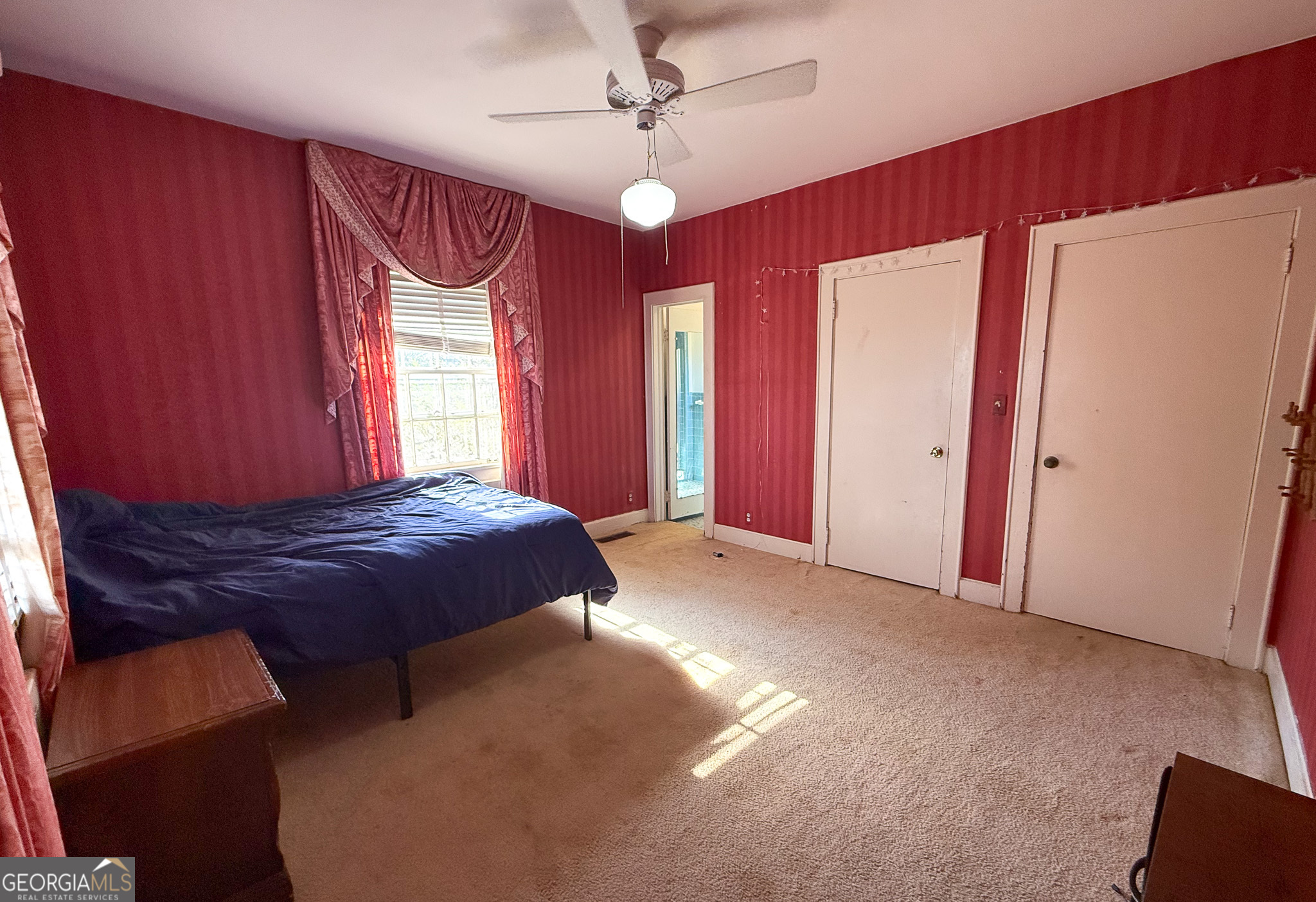 509 Youngs Mill Road LaGrange, GA 30241 - Photo 23 of 28 a spacious bedroom with a bed and a chandelier