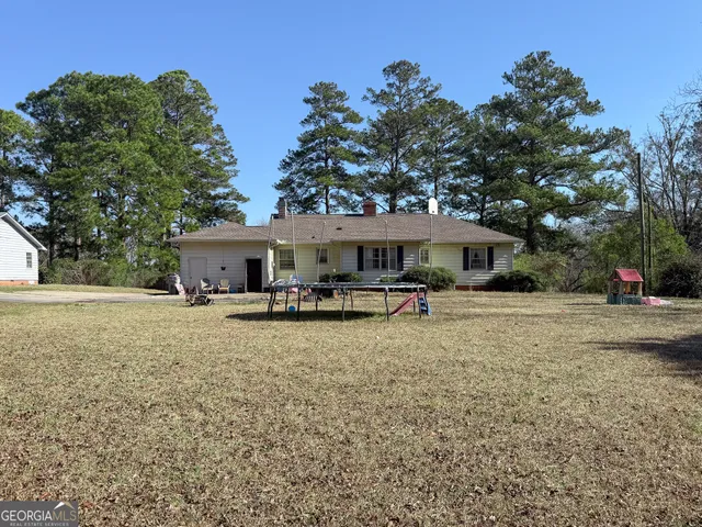 a front view of a house with yard and green space