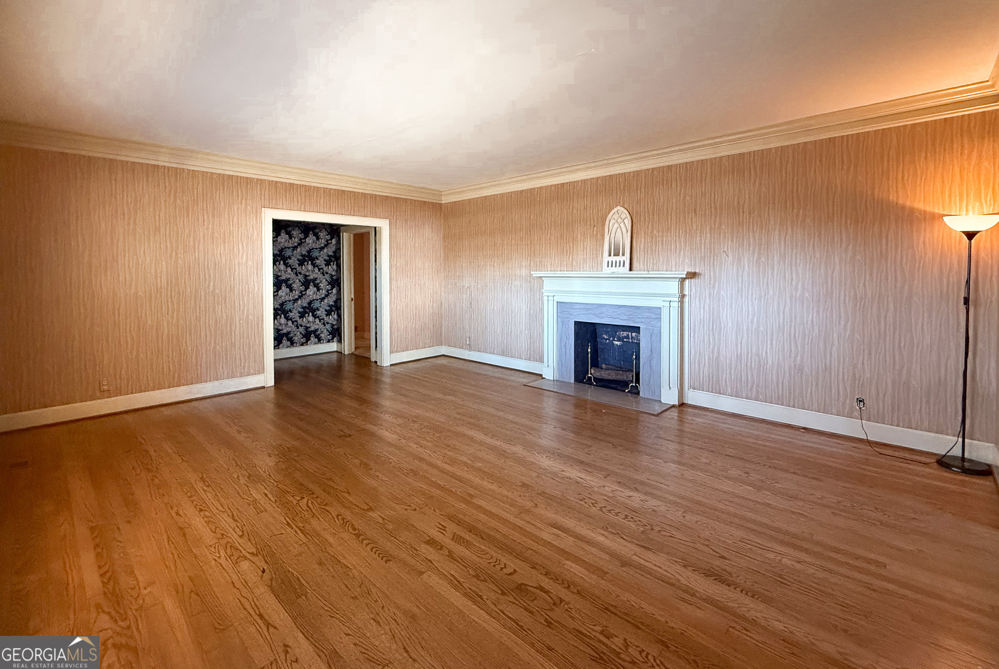 509 Youngs Mill Road LaGrange, GA 30241 - Photo 4 of 28 an empty room with wooden floor fireplace and windows