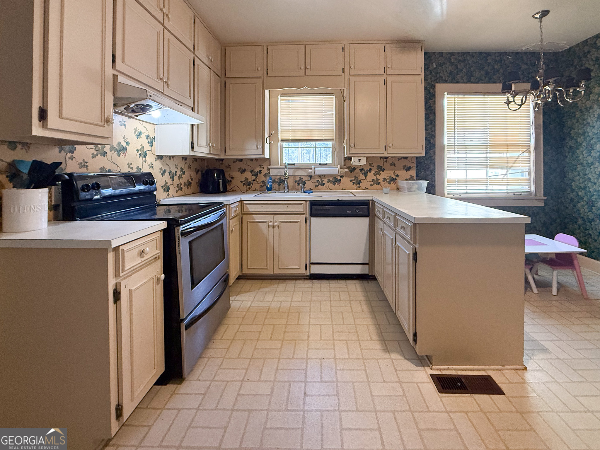 509 Youngs Mill Road LaGrange, GA 30241 - Photo 7 of 28 a kitchen with stainless steel appliances granite countertop a stove a sink and a microwave