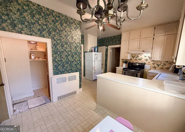 a kitchen with stainless steel appliances a refrigerator and a stove top oven