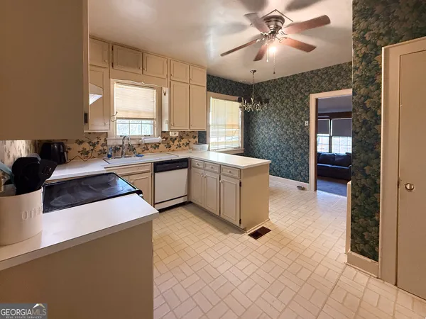 a kitchen with a sink a stove and cabinets