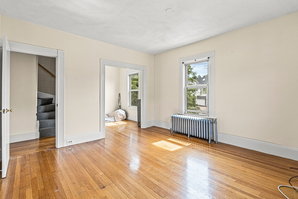 16 Porter Street, Unit 2 Somerville, MA 02143 - Photo 12 of 26 wooden floor in an empty room with a window