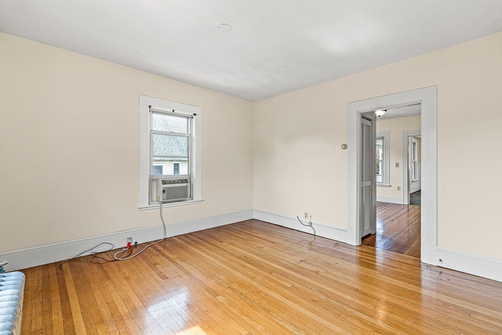 16 Porter Street, Unit 2 Somerville, MA 02143 - Photo 14 of 26 an empty room with wooden floor and windows