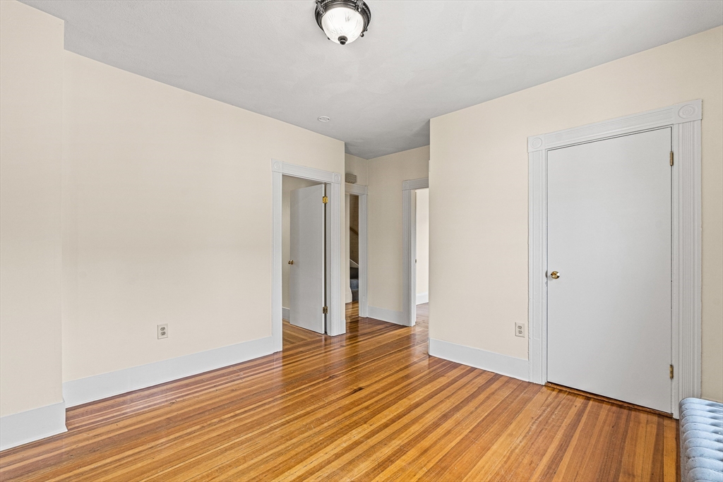16 Porter Street, Unit 2 Somerville, MA 02143 - Photo 17 of 26 a view of an empty room with wooden floor