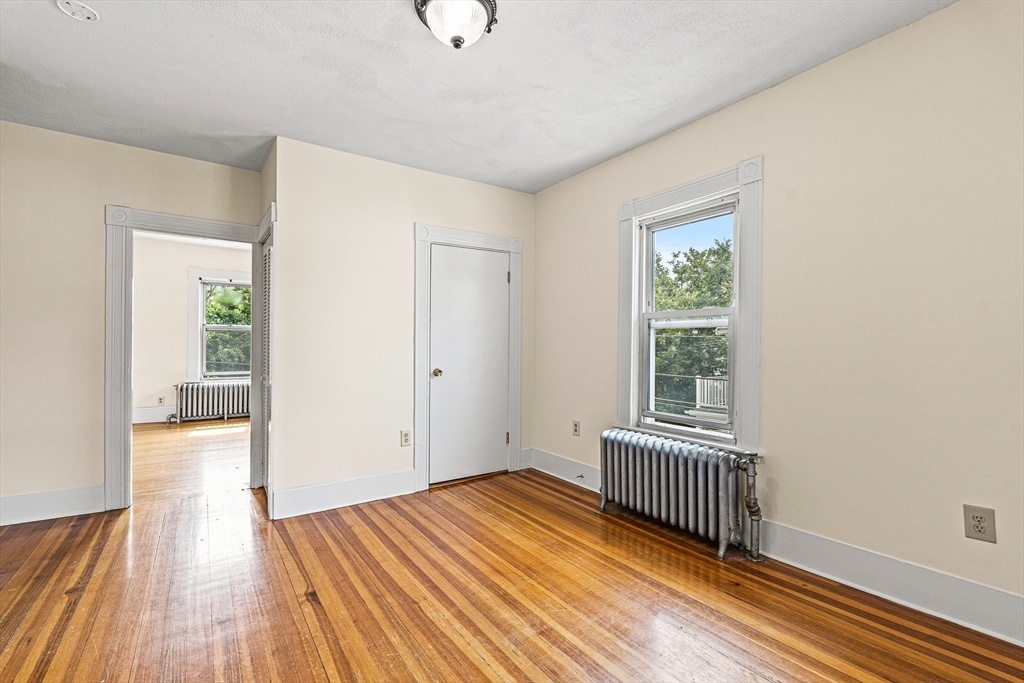 16 Porter Street, Unit 2 Somerville, MA 02143 - Photo 19 of 26 wooden floor in an empty room