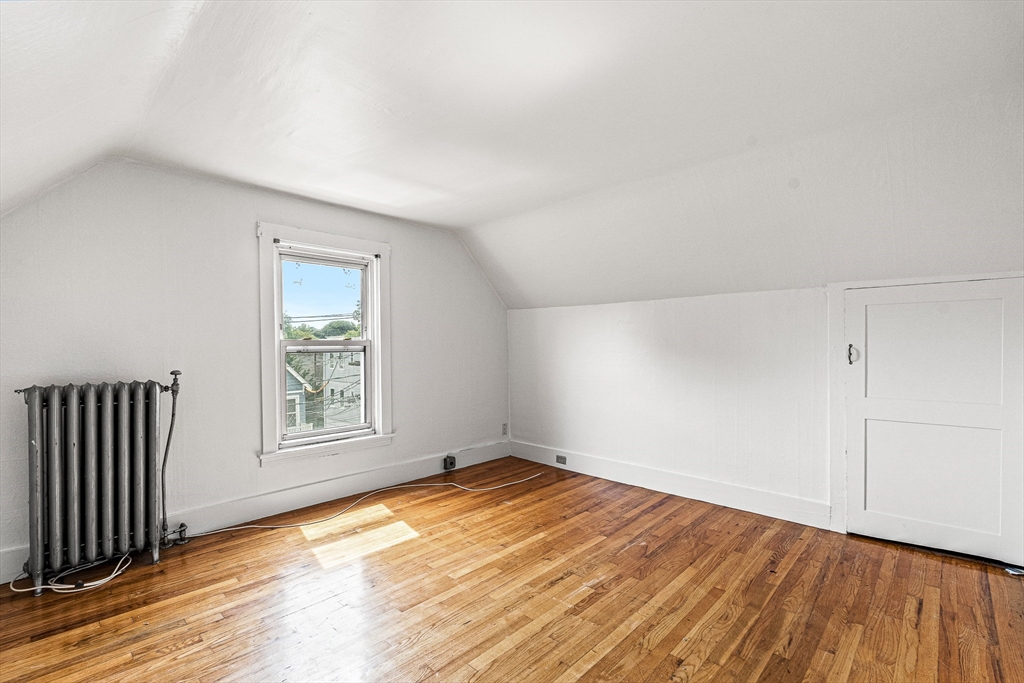 16 Porter Street, Unit 2 Somerville, MA 02143 - Photo 20 of 26 an empty room with wooden floor and windows