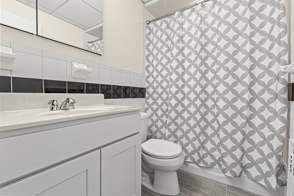 16 Porter Street, Unit 2 Somerville, MA 02143 - Photo 8 of 26 a bathroom with a sink a toilet and a mirror