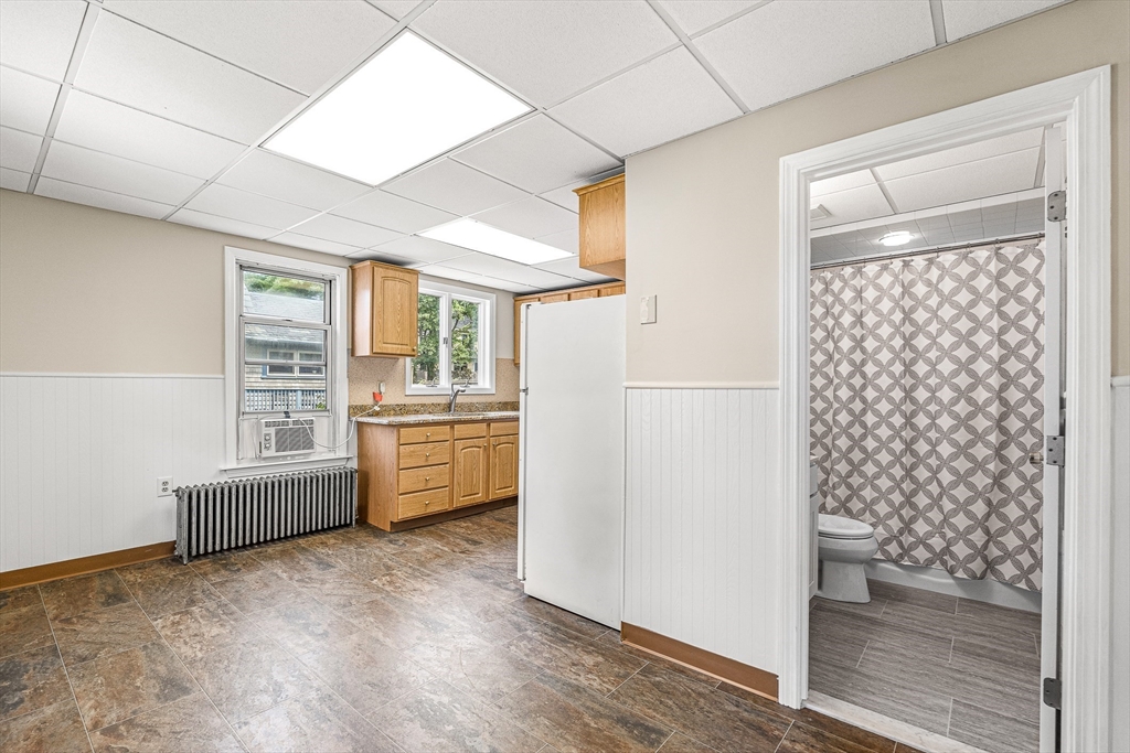 16 Porter Street, Unit 2 Somerville, MA 02143 - Photo 9 of 26 a kitchen with granite countertop cabinets and refrigerator