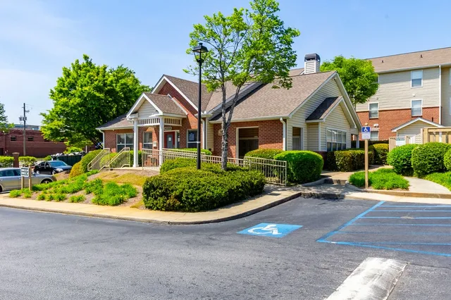 a front view of a house with a yard and potted plants