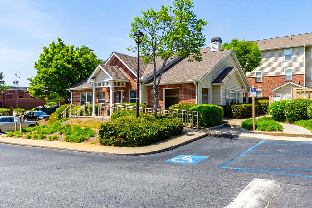 a front view of a house with a yard and potted plants
