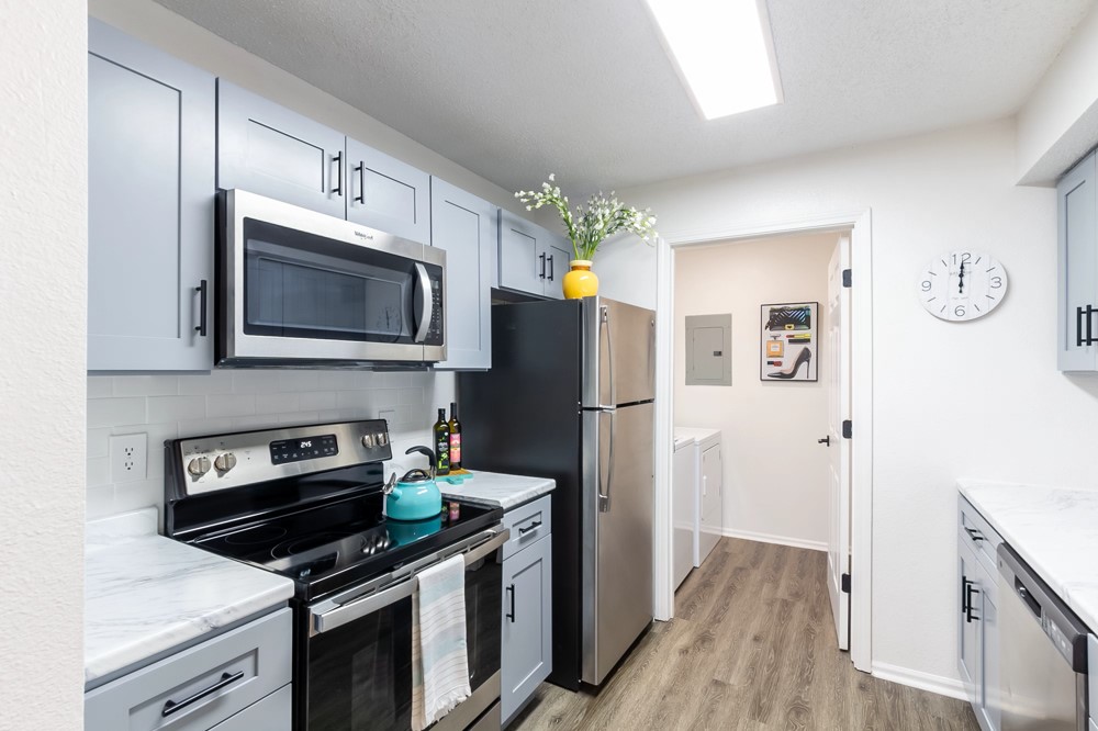 835 Oglethorpe Avenue Southwest Atlanta, GA 30310 - Photo 23 of 39 a kitchen with stainless steel appliances a stove microwave and a refrigerator
