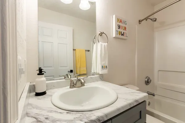 a bathroom with a sink and a mirror