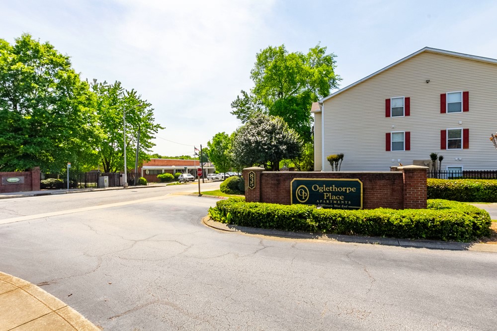 835 Oglethorpe Avenue Southwest Atlanta, GA 30310 - Photo 4 of 39 a view of a white house with a yard and potted plants