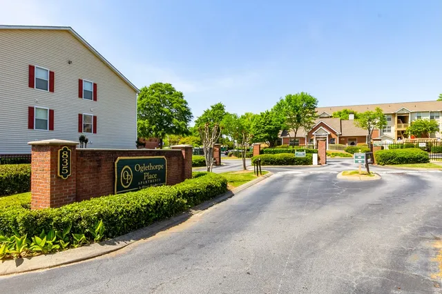 a sign board with a road sign on the side of the road