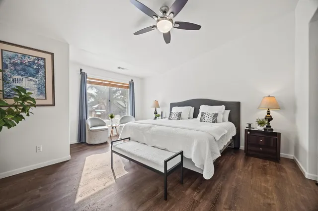 a bedroom with a bed and a potted plant