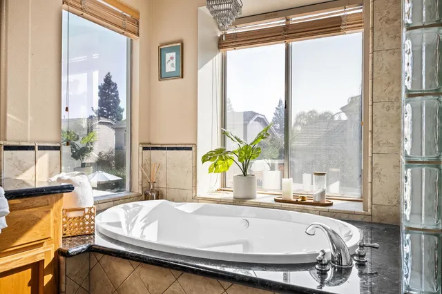 a bed sitting in a balcony next to a window