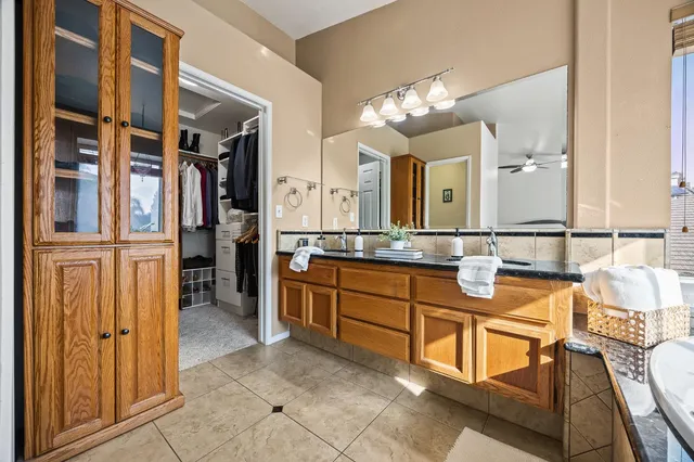 a spacious bathroom with a double vanity sink and a mirror