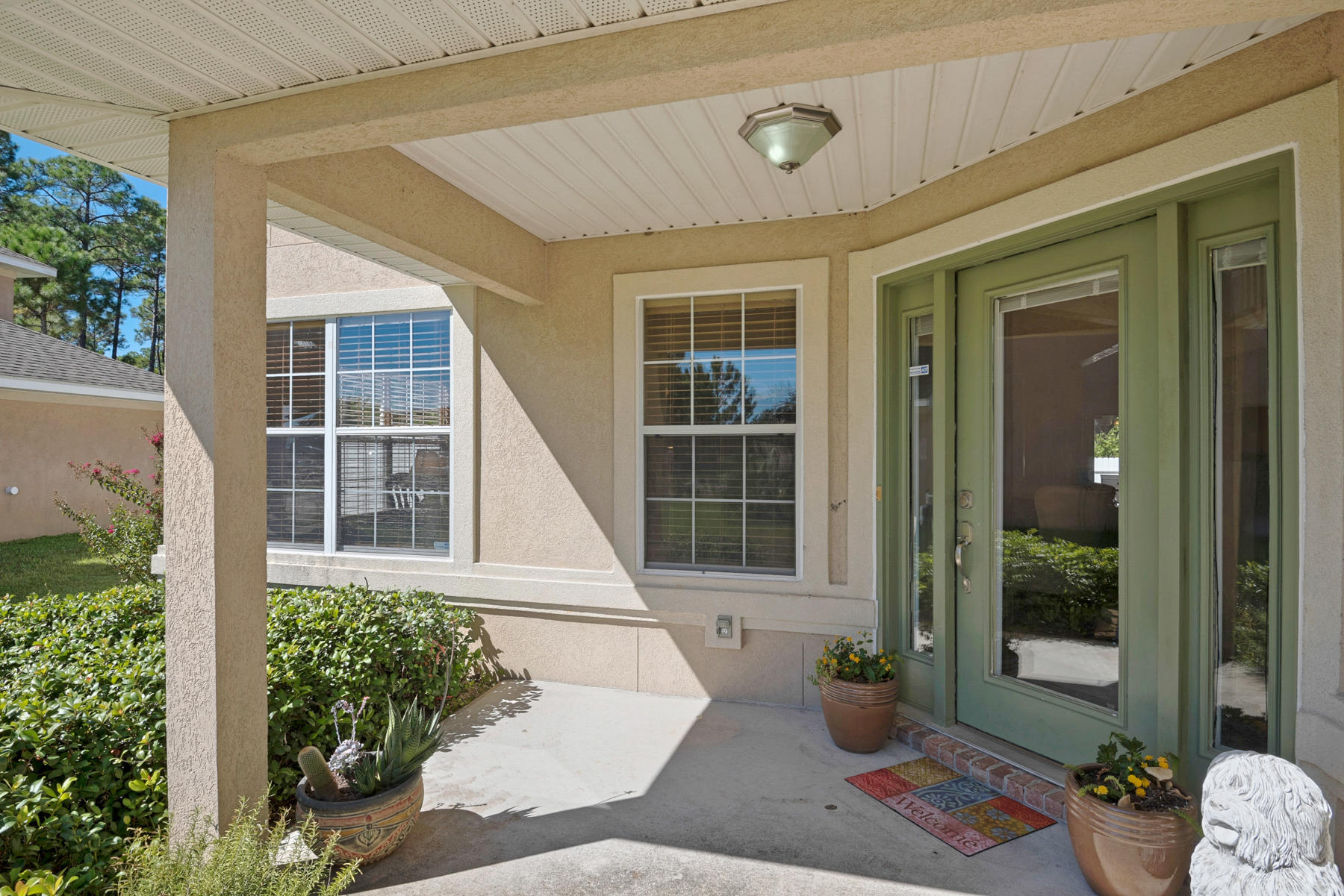 30 Red Maple Court Santa Rosa Beach, FL 32459 - Photo 2 of 36 front view of a house with a potted plant and floor to ceiling windows