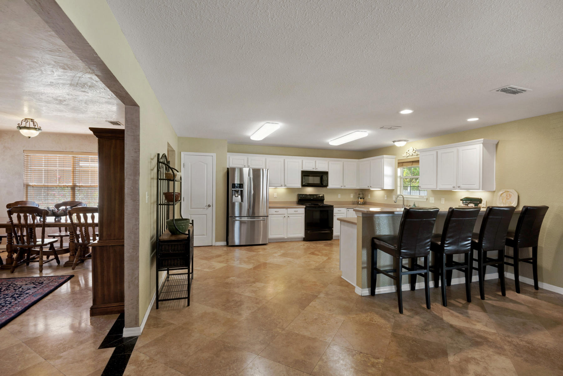 30 Red Maple Court Santa Rosa Beach, FL 32459 - Photo 10 of 36 a open kitchen with lots of counter space a refrigerator a dining table and chairs