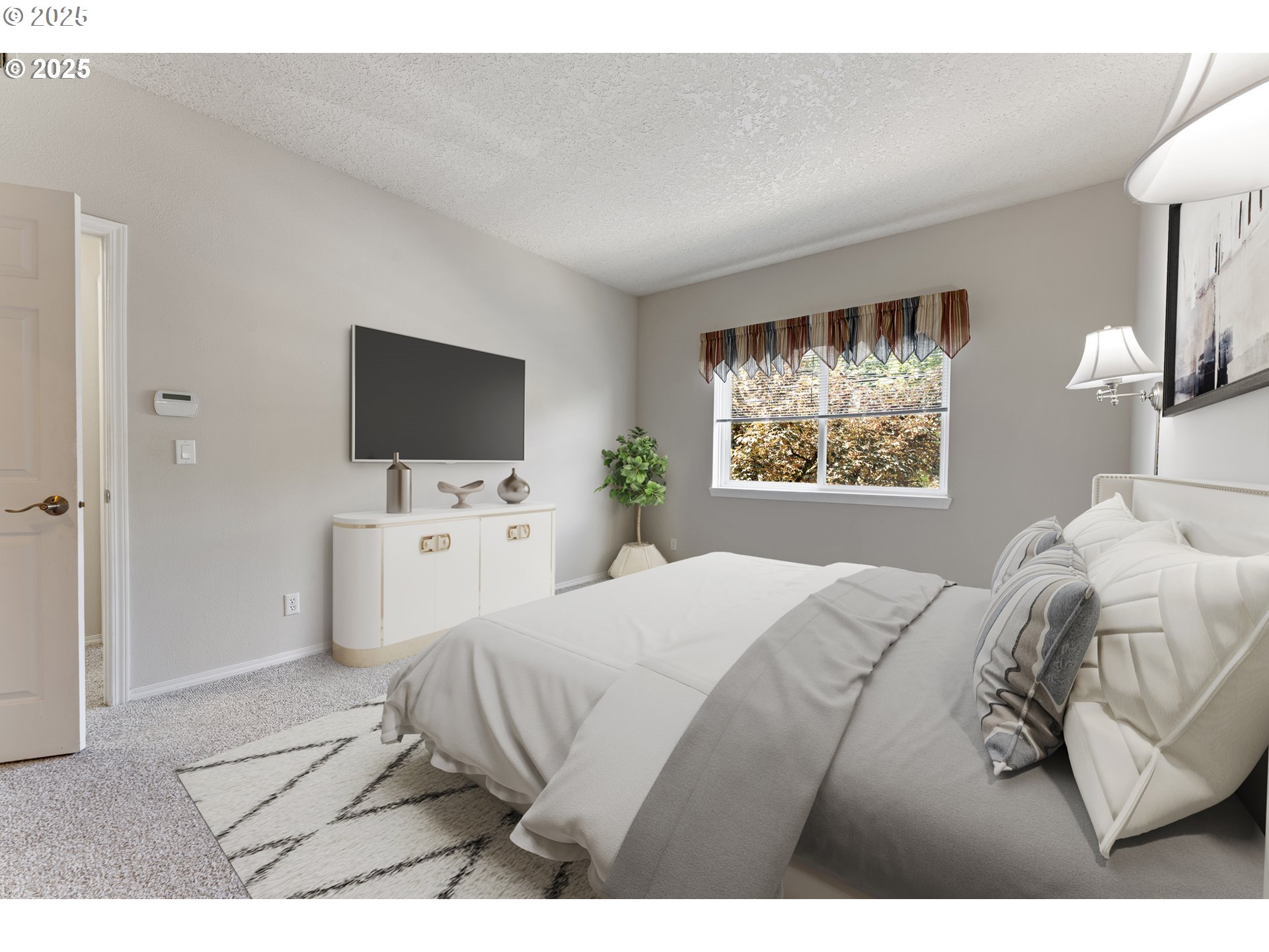 4320 South Corbett Avenue, Unit 202 Portland, OR 97239 - Photo 13 of 33 a bedroom with a bed tv and a window