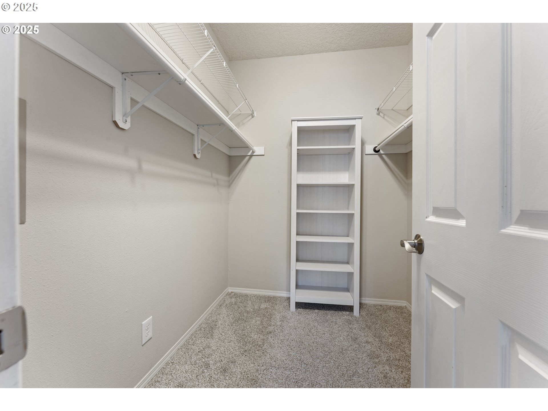 4320 South Corbett Avenue, Unit 202 Portland, OR 97239 - Photo 14 of 33 a view of walk in closet with empty racks