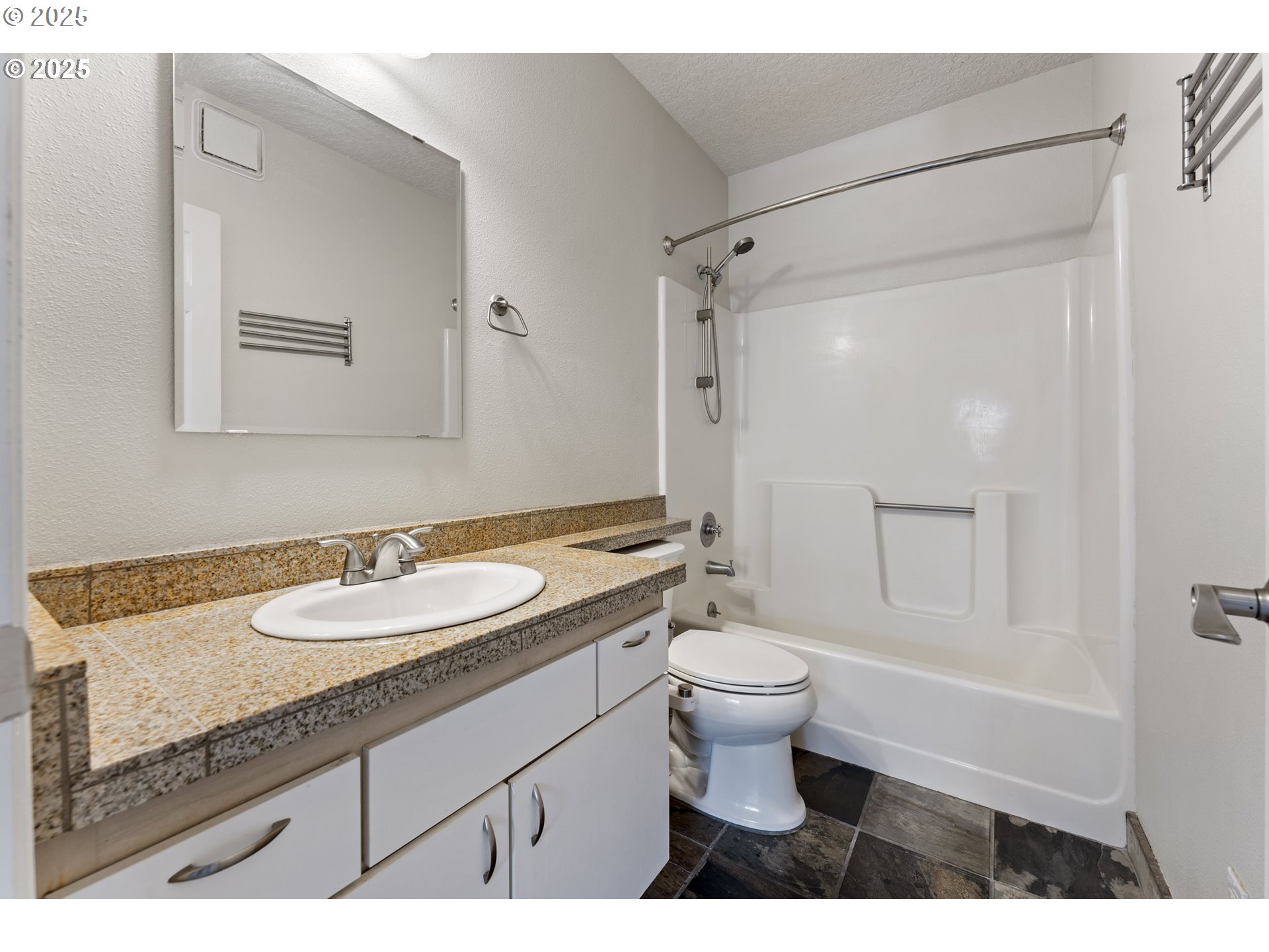 4320 South Corbett Avenue, Unit 202 Portland, OR 97239 - Photo 15 of 33 a bathroom with a granite countertop sink toilet a mirror and shower
