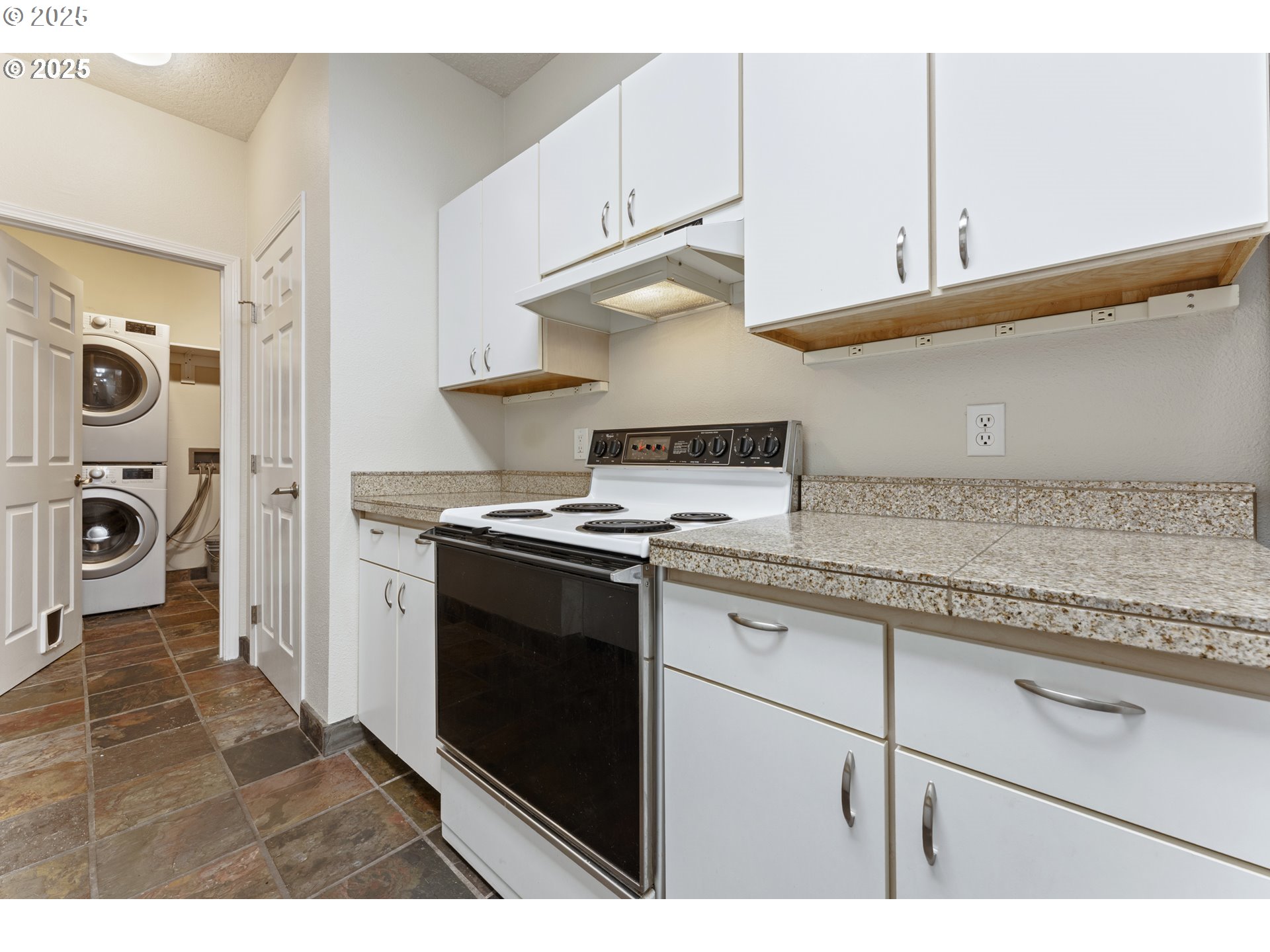 4320 South Corbett Avenue, Unit 202 Portland, OR 97239 - Photo 23 of 33 a kitchen with granite countertop a stove and a sink