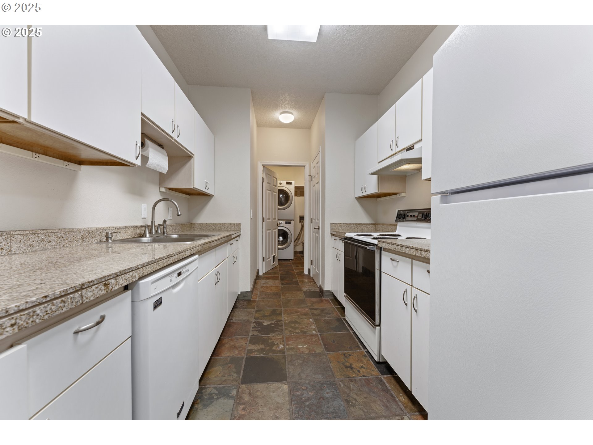 4320 South Corbett Avenue, Unit 202 Portland, OR 97239 - Photo 26 of 33 a large kitchen with stainless steel appliances granite countertop a stove a sink and dishwasher