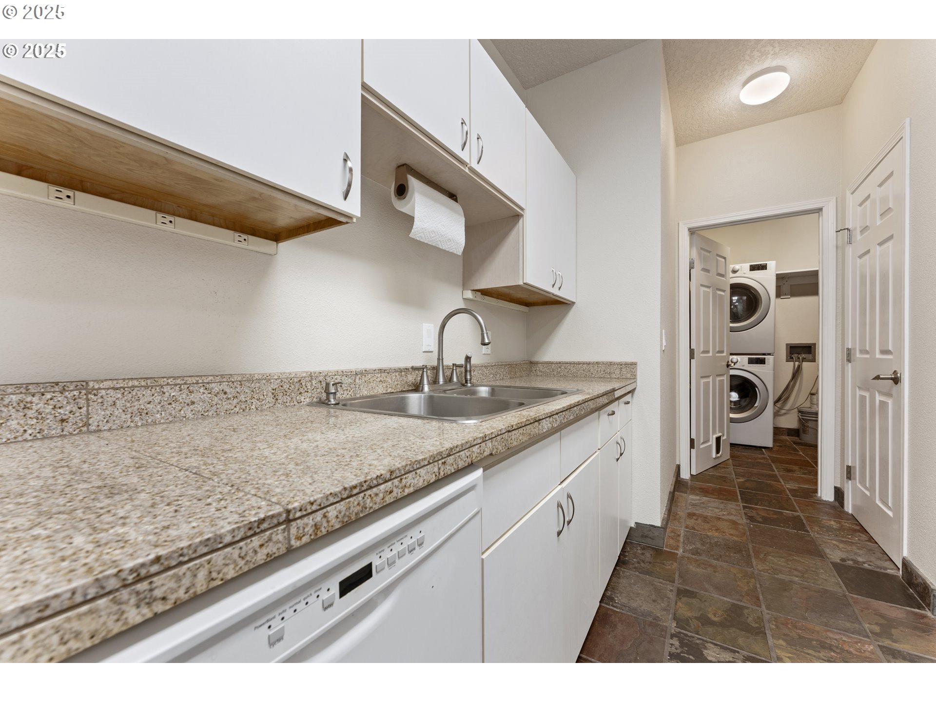 4320 South Corbett Avenue, Unit 202 Portland, OR 97239 - Photo 27 of 33 a bathroom with a granite countertop sink and a mirror