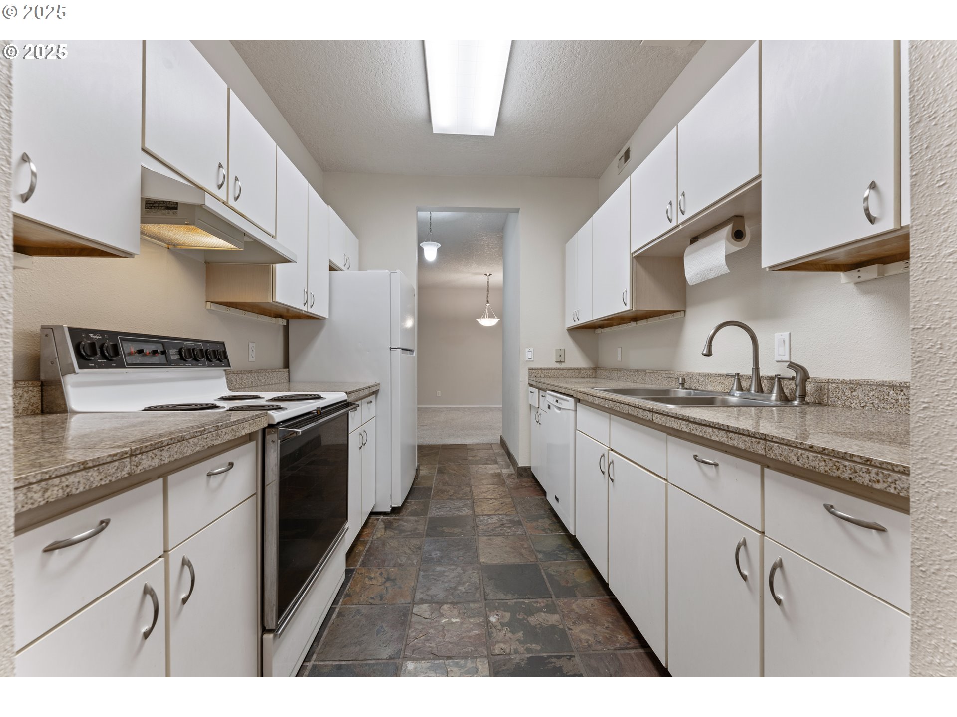 4320 South Corbett Avenue, Unit 202 Portland, OR 97239 - Photo 28 of 33 a kitchen with granite countertop a sink dishwasher stove and cabinets